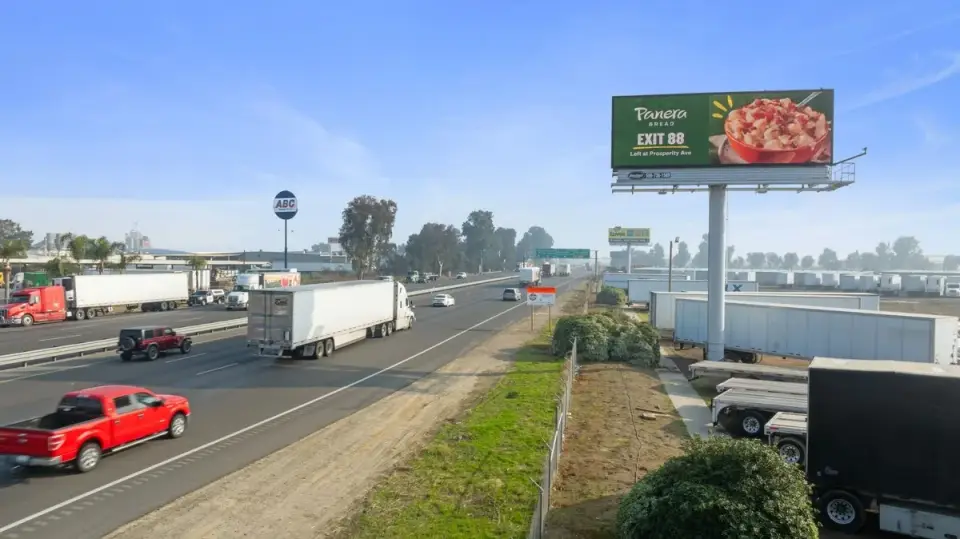 Digital food advertisement overlooking Highway 99 traffic in Goshen