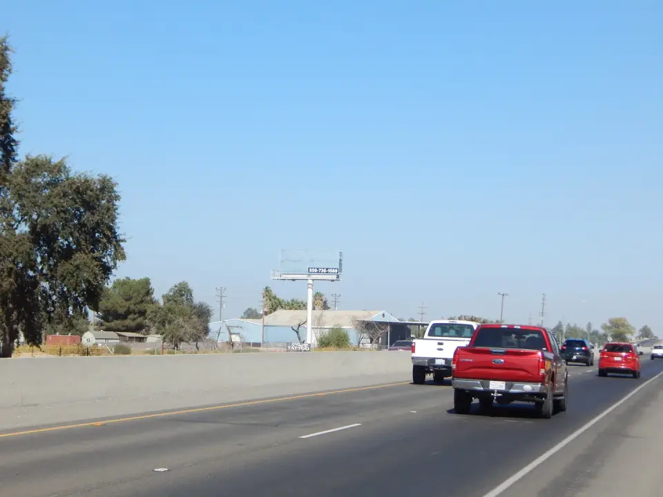 Roadside billboard set against fields near Hanford