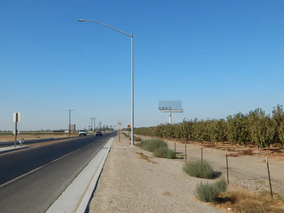 Blank billboard beside an orchard and highway near Hanford