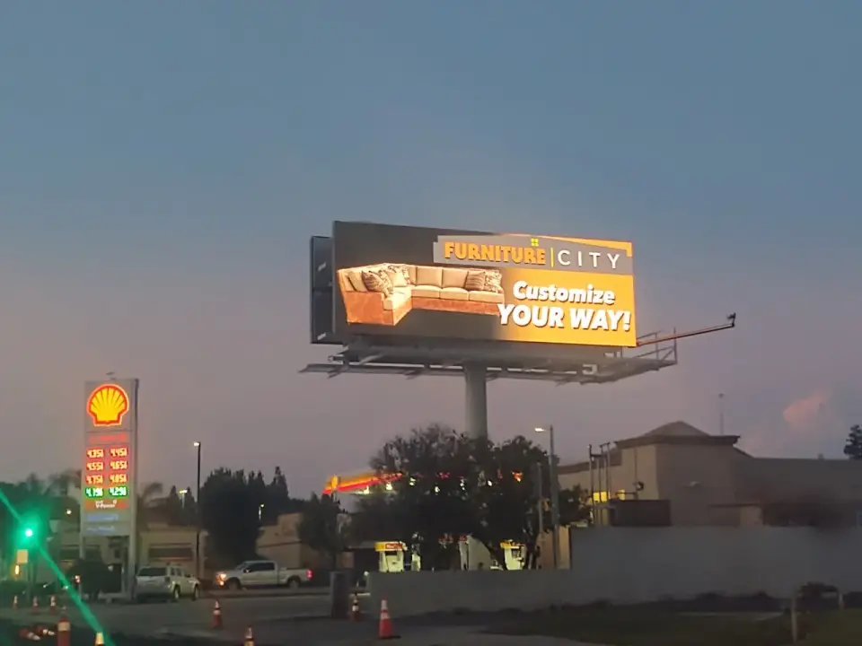 Furniture City digital billboard illuminated after dark in Bakersfield