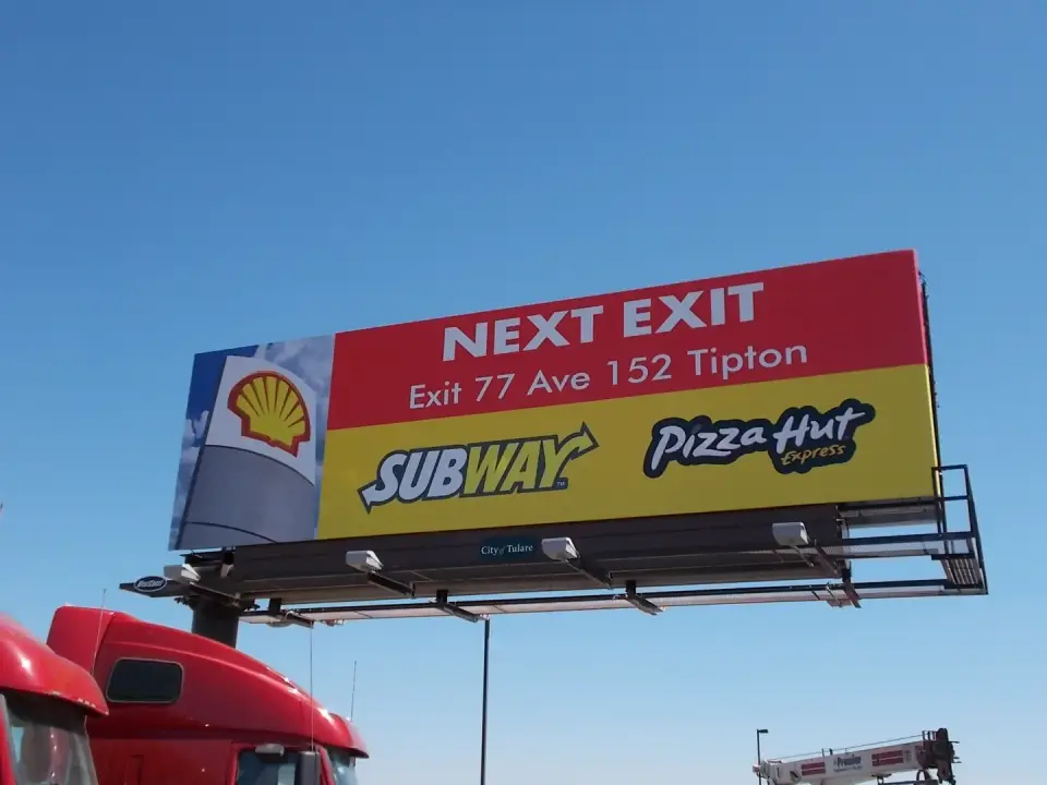 Shell, Subway, and Pizza Hut next-exit billboard near Tulare