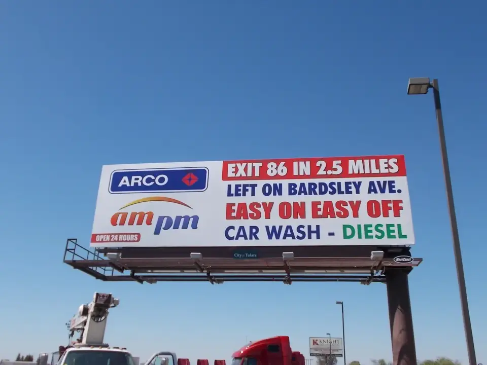 ARCO and ampm exit-direction billboard beside Highway 99 in Tulare